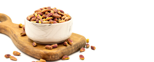 Pistachio kernel isolated on white background. A bowl of pistachios. close up. Copy space. Space for text