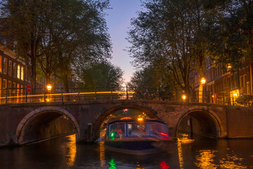 Dusk on the Amsterdam Canal and a Boat Under the Bridge