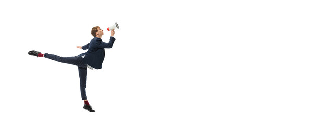 Studio shot of young male ballet dancer wearing business suit dancing isolated on white studio...