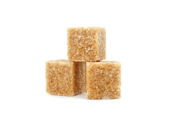 Brown cane sugar isolated on white background. Three cubes or pieces of sugar.