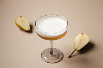 Amaretto sour cocktail in a coupe glass centered with pears around. - obrazy, fototapety, plakaty