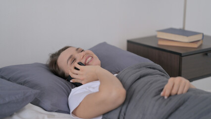 Woman Talking on Phone while Sleeping in Bed