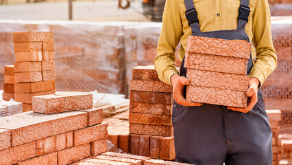 contractor builder holding bricks in his hands.