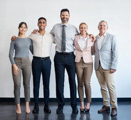 Its a great day to expand the team. Shot of a group of businesspeople standing in an office at work.