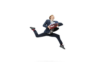 Young man in dark business suit jumping, flying isolated on white background. Art, motion, action, flexibility, inspiration concept.