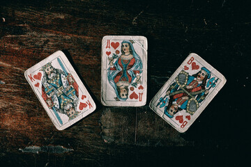 old playing cards for poker on a wooden table
