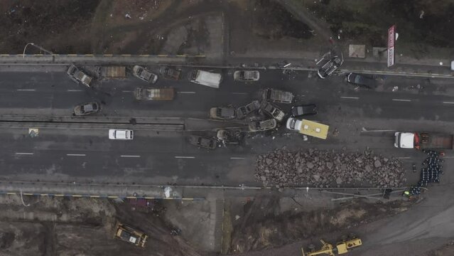 Abandoned cars near the destroyed bridge across the Irpin River. War in Ukraine. City of Irpin.