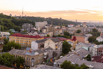 Fototapeta na wymiar Ukraine, Kyiv – July 04, 2015: Aerial panoramic view on central and historical part, area of city Podil with residential buildings in the evening, during the sunset. Pre-revolutionary buildings