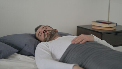 Fototapeta premium Man Sleeping in Bed Peacefully