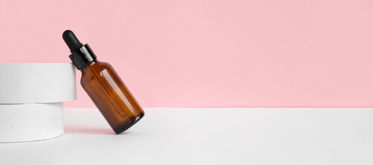 Amber glass dropper cosmetic bottle, white podium. Natural skin care SPA beauty product design. Mineral organic oil on beige background. Mock-Up. Oily pipette. Face and body treatment. Front view