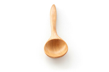 A wooden spoon is placed on a white ceramic background. Concept of isolated objects on a white...