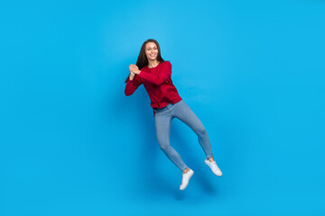 Fototapeta na wymiar Full size photo of cute millennial ung lady jump wear eyewear shirt jeans sneakers isolated on blue background