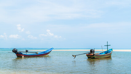 Naklejka na ściany i meble Traditional fishing boats on seaside vacation with blue sky summer season 