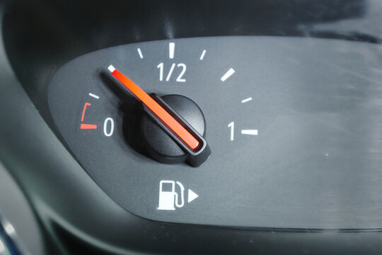 Close up of a fuel gauge showing a quarter full fuel tank in a car, gasoline consumption.