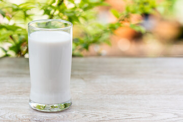 World Milk Day, Glass of white milk on a wooden desk, blurred background, close up. Happy Milk Day. Dairy product concept, copy space on right for design or content, nobody, World Milk Day 1 June