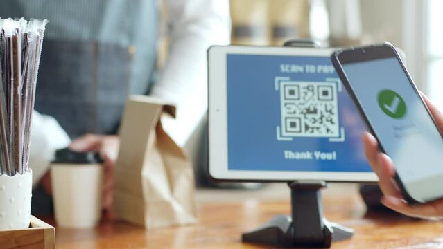 QR code payment, customer using smartphone for paying at shop