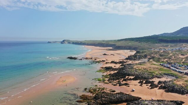 Liencres Dunes Natural Park beach at sunny day in summer. Aerial