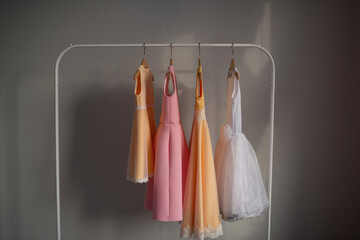 Dresses for girls are hanging on a hanger. Children's clothing.
