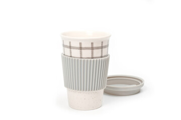 Checkered ceramic cup with rubber lid, shot against a white background.