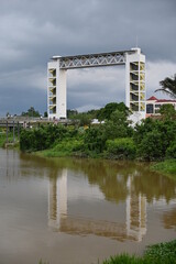 Fototapeta premium The Batu Kawa Waterfront Riverside Park, landmark sky bridge and its surrounding parks