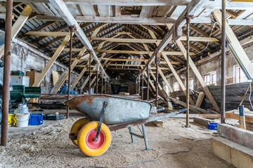 Wheelbarrow with Yellow tires inside old abandoned warehouse