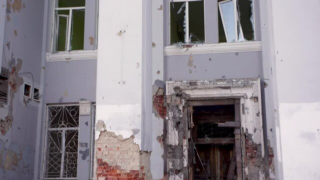Damaged ruined civilian building in ukrainian city Chernihiv near Kyiv on north of Ukraine. Ruins during War of Russia against Ukraine in 2022. Walls, broken windows of buildings. Aircraft, artillery