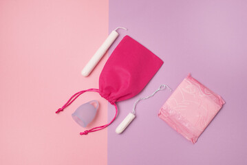 Pad Menstrual Cup Tampon on Pink and Purpl Background The view is flat Concept of critical days menstruation