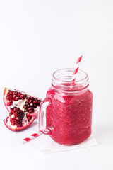 Pomegranate Smoothie in Glass Jar on White Background