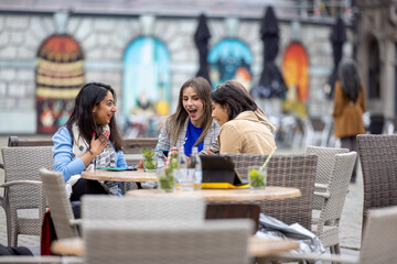 Diverse group of young business woman drinking cocktails in an European city . High quality photo