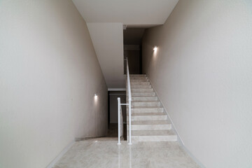 new clean corridor with stairs in a large house white railings