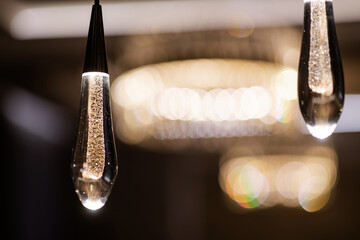 lamp in the form of a glass drop in loft style in the interior