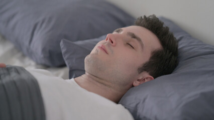 Fototapeta na wymiar Man Waking up from Sleep in Bed, Close up