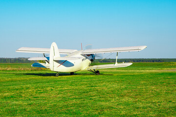 Fly airplane on green grass and blue sky clear background selective focus