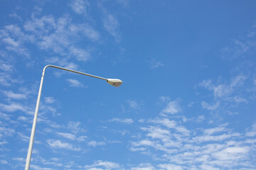 Light poles to illuminate the road blue sky background