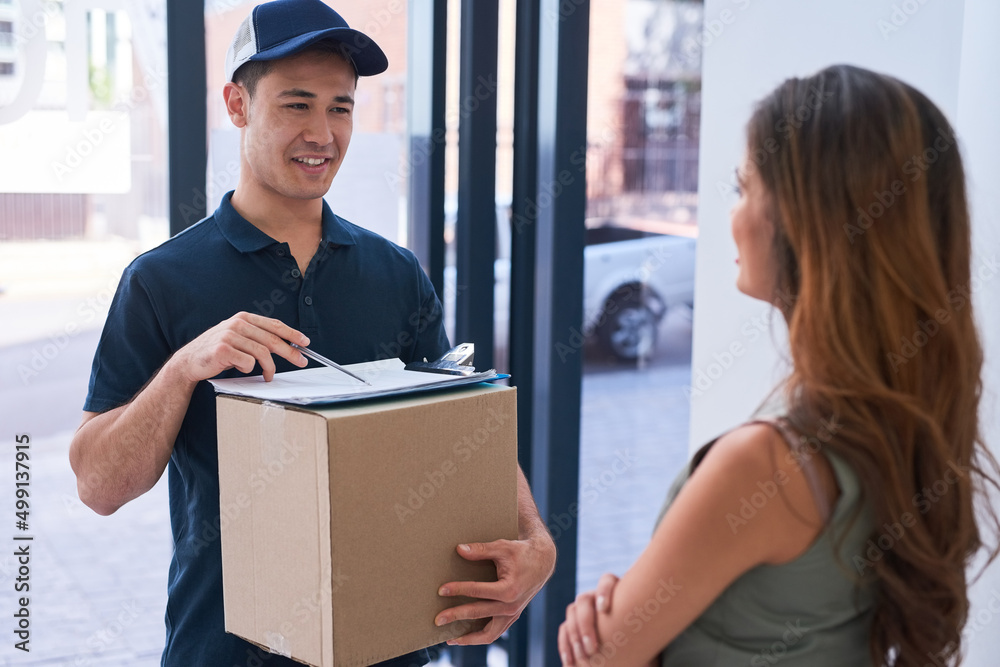 Wall mural Getting your package delivered on time every time. Cropped shot of a courier making a delivery to a businesswoman.