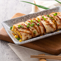 Delicious Taiwanese omelette, egg pancake roll with ham and corn kernels.