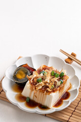 Delicious Chilled tofu and century egg with soy sauce and bonito flakes.