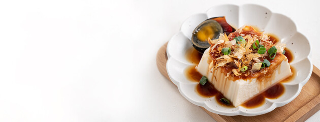 Delicious Chilled tofu and century egg with soy sauce and bonito flakes.