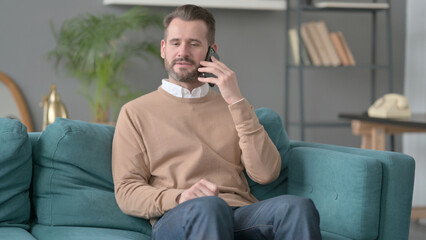 Man Talking on Phone on Sofa 