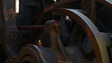 A metal circle. Part of an old metal mechanism. Rusty metal construction. Old mechanism background