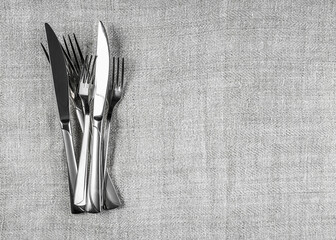 Lot of cutlery on linen tablecloth, abstract food background