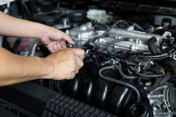 Man use Open-ended wrench for basic car repairs by yourself in engine room , car service concept