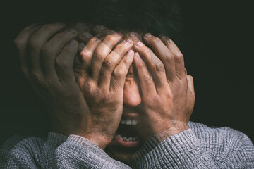 When your mind is your own worst enemy. Studio shot of a young man experiencing mental anguish and screaming against a black background.