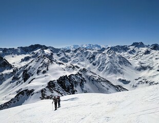 Ski touring couple on the ascent towards the Schwarzhorn near Davos Klosters Mountains. Ski mountaineering in the Swiss Alps