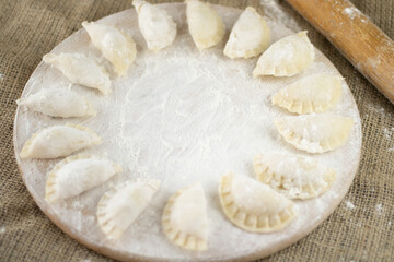 Raw dumpling with potatoes. Preparation dumplings on a wooden board.
