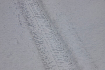 Winter trail from a car wheel in the snow, close-up