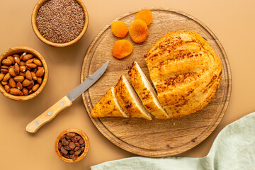 Loaf with dried fruits and nuts. Healthy homemade bread top view