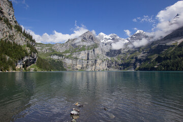Lake Oeschinen (Oeschinensee) seen from the shore with moutains in the background