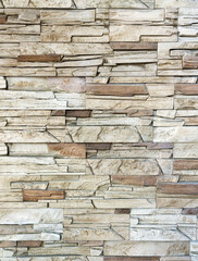 The wall is rough stone. Fragment of masonry. Natural stone