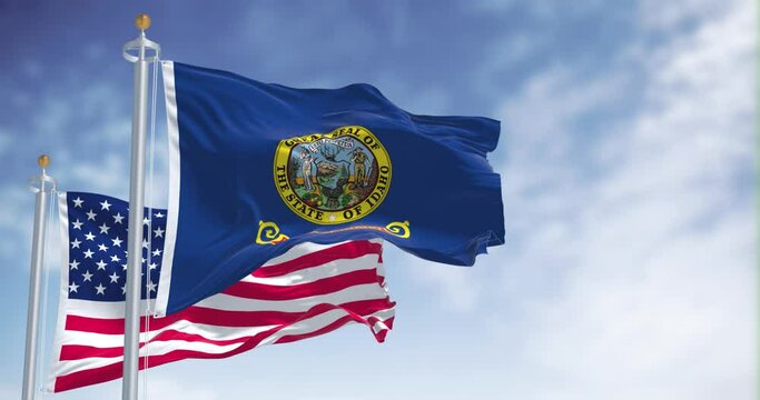 The Idaho state flag waving along with the national flag of the United States of America